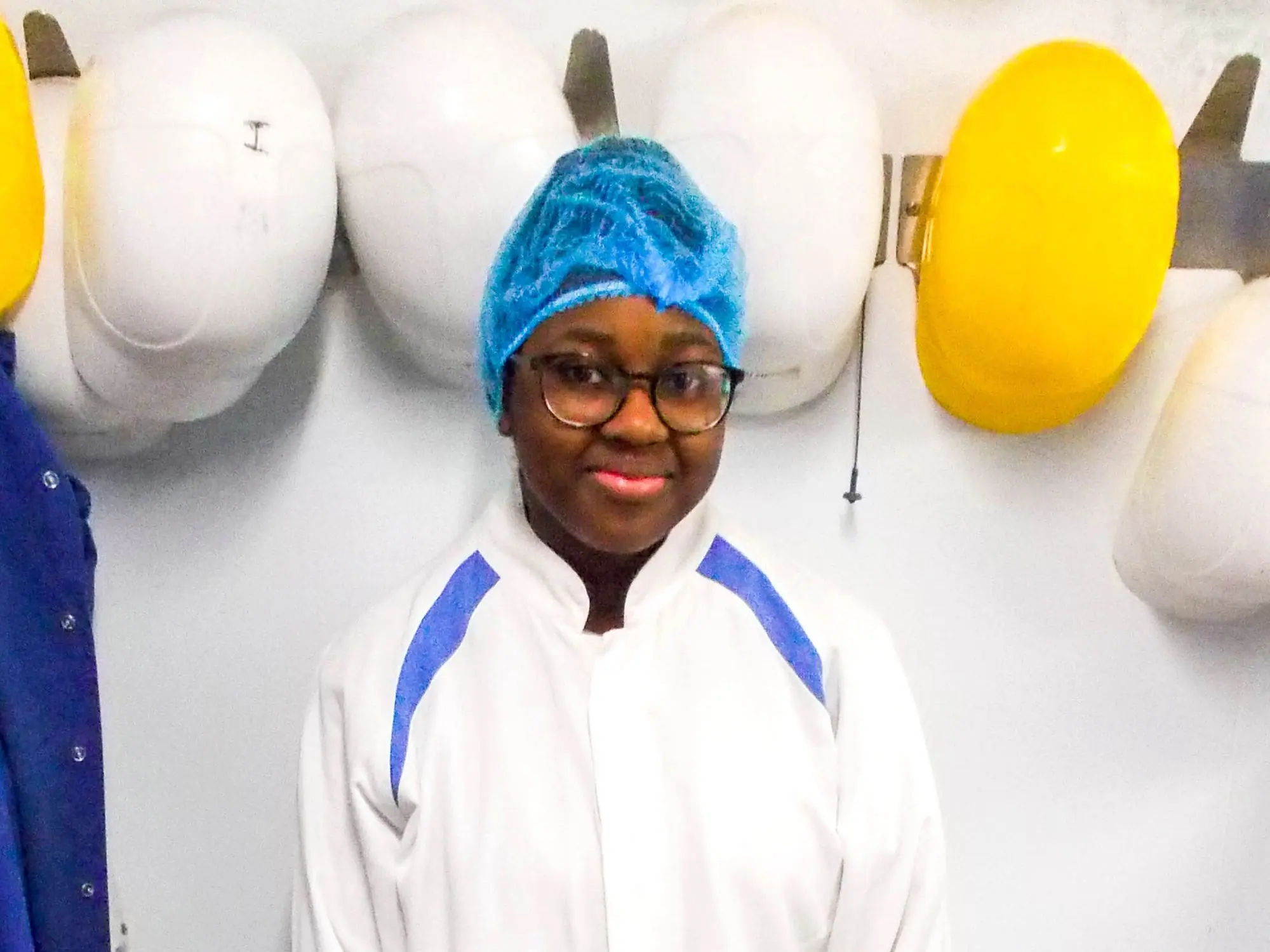 A Foundation Apprentice in whites and a blue hairnet, smiling, at Browns' Kirkconnel site