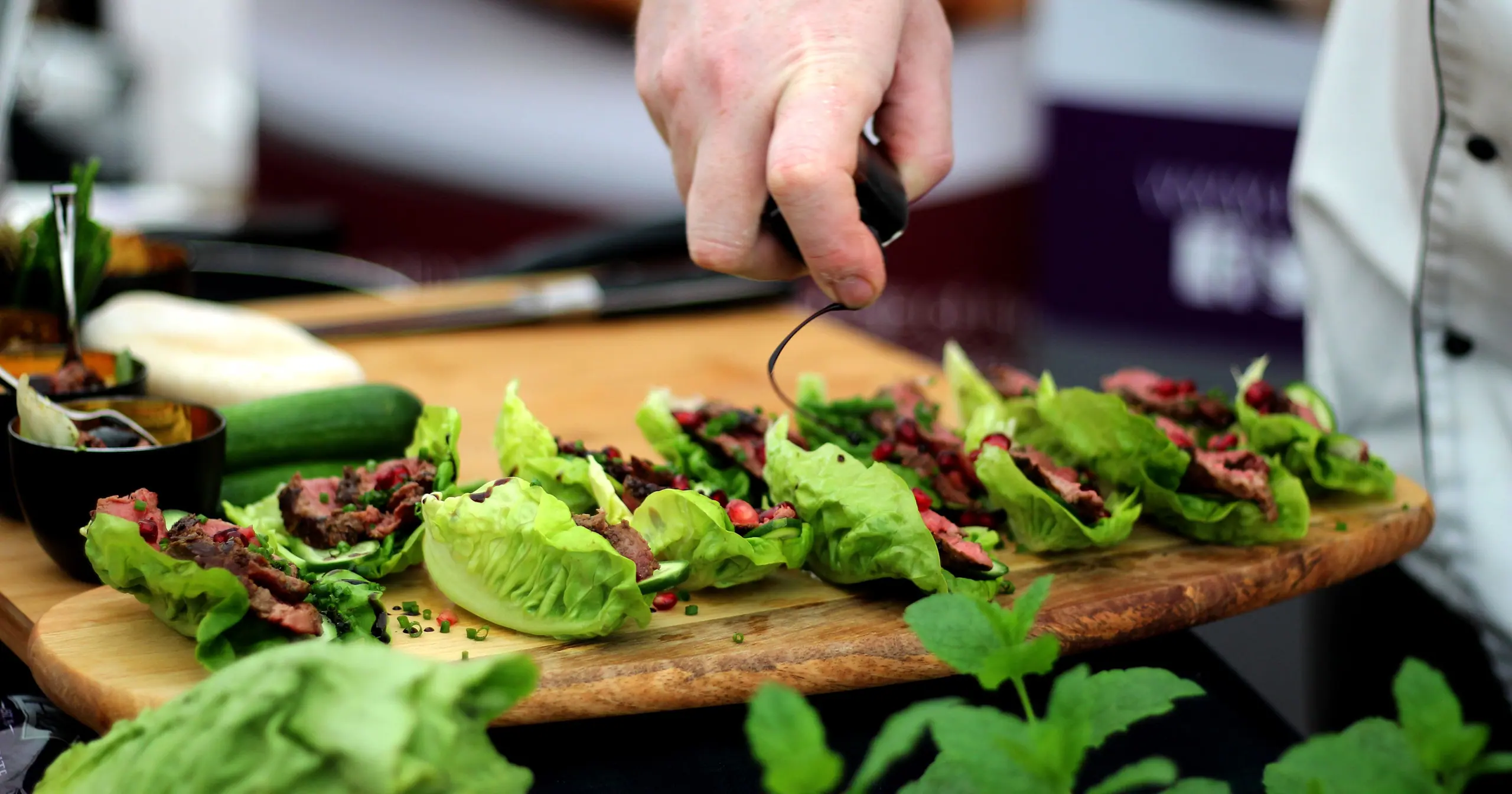Sliced roast beef with salad leaves on a wooden board, prepared by the Browns development kitchen for a trade show